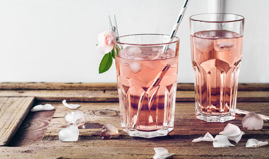 a photo of rose water ice cream with rose water in a glass